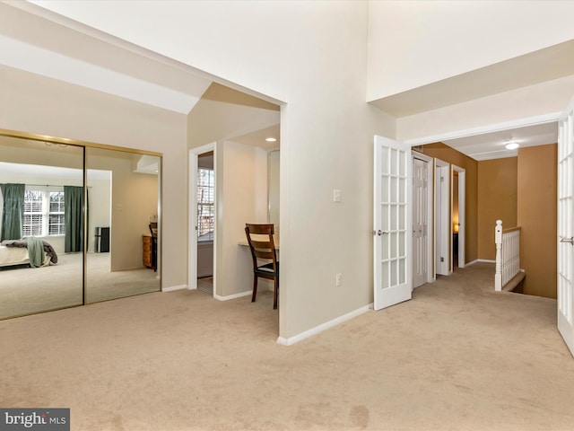 interior space with a closet, baseboards, and french doors