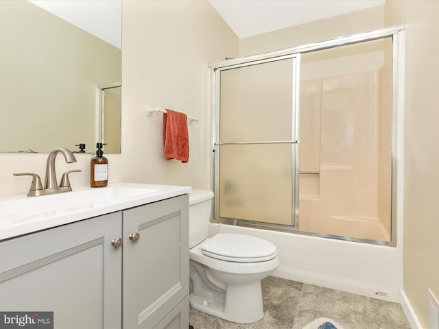 full bath featuring vanity, toilet, and bath / shower combo with glass door