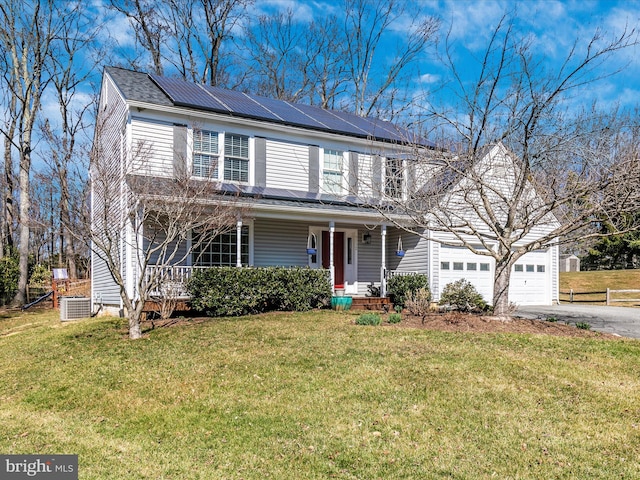 view of front of house with roof mounted solar panels, cooling unit, a porch, and a front yard