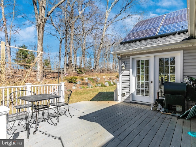 wooden terrace with outdoor dining area