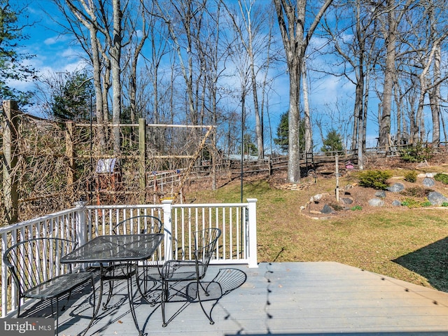 wooden deck with a yard and fence