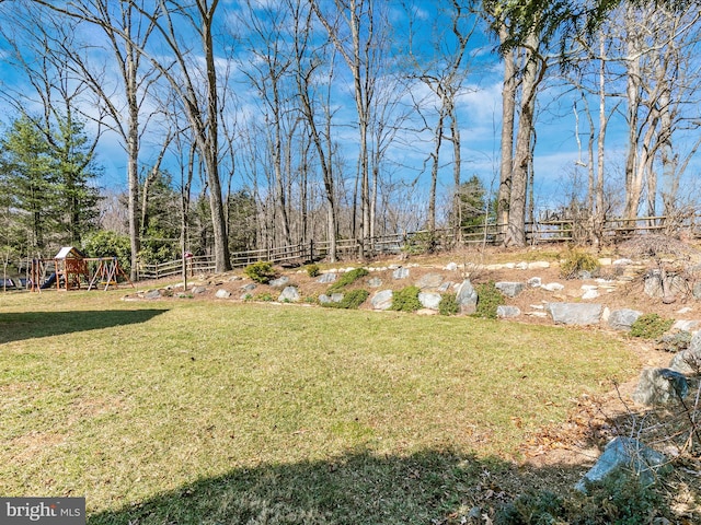 view of yard with a playground and fence