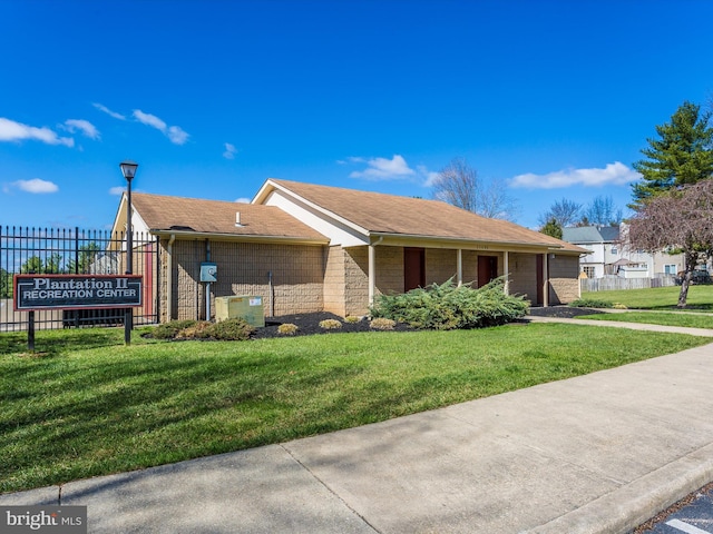 view of side of home featuring central air condition unit, fence, and a lawn