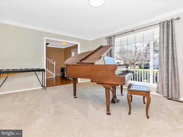 sitting room featuring visible vents, baseboards, carpet, and ornamental molding