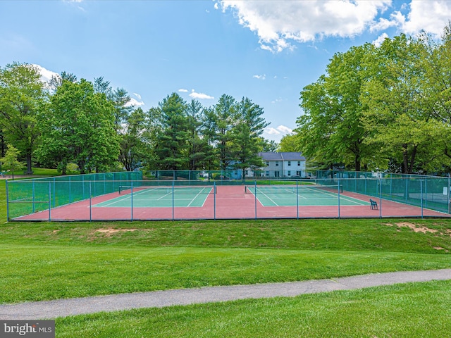 view of sport court featuring a yard and fence