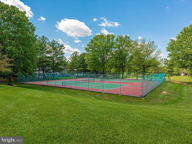 view of sport court featuring a lawn and fence