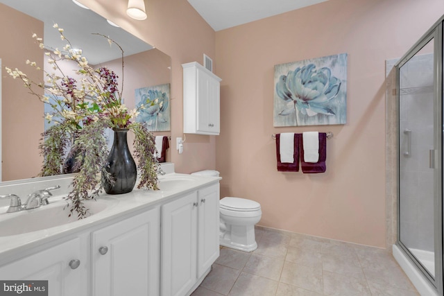 bathroom featuring a sink, a stall shower, double vanity, and tile patterned flooring