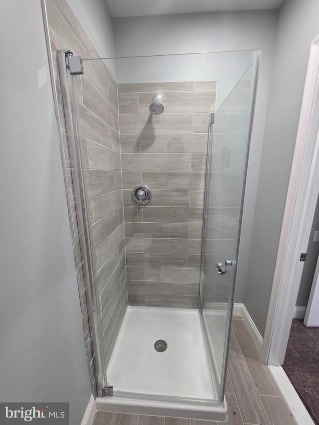 full bath featuring baseboards and a stall shower