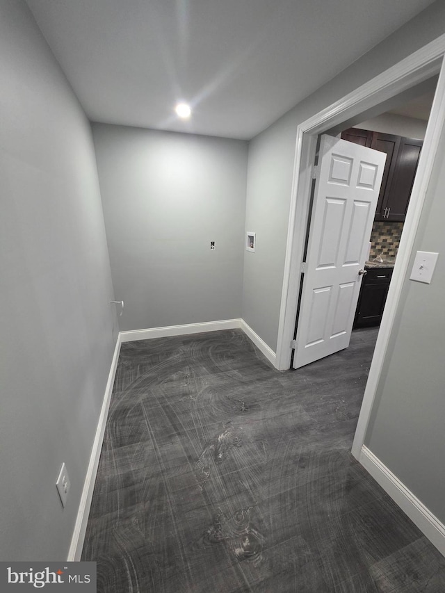 spare room with baseboards