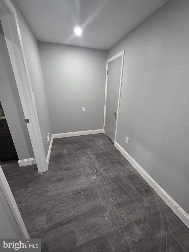 unfurnished room featuring baseboards