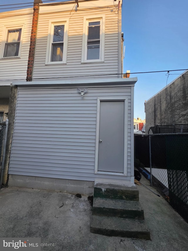 back of house featuring fence and entry steps