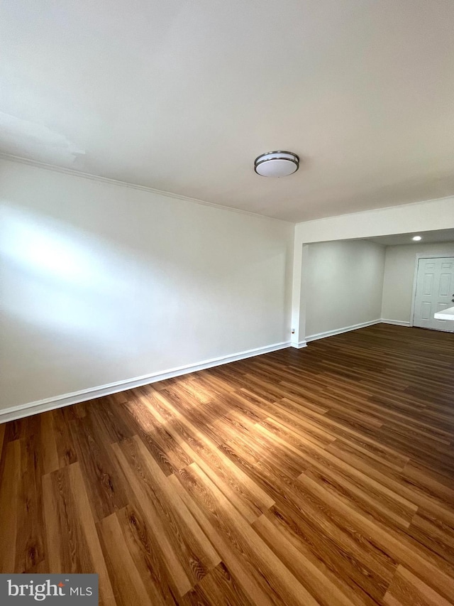 spare room featuring wood finished floors and baseboards