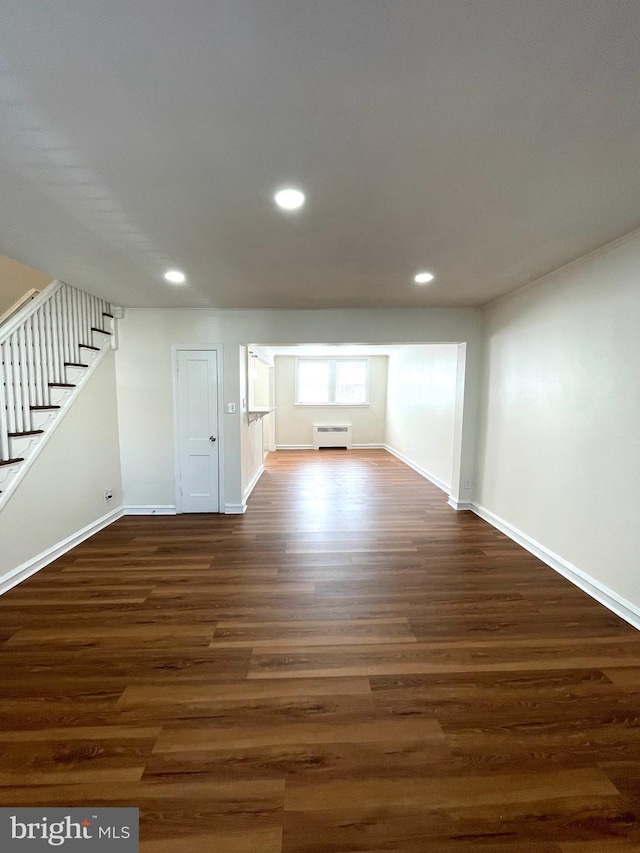 unfurnished living room with stairs, recessed lighting, dark wood finished floors, and baseboards