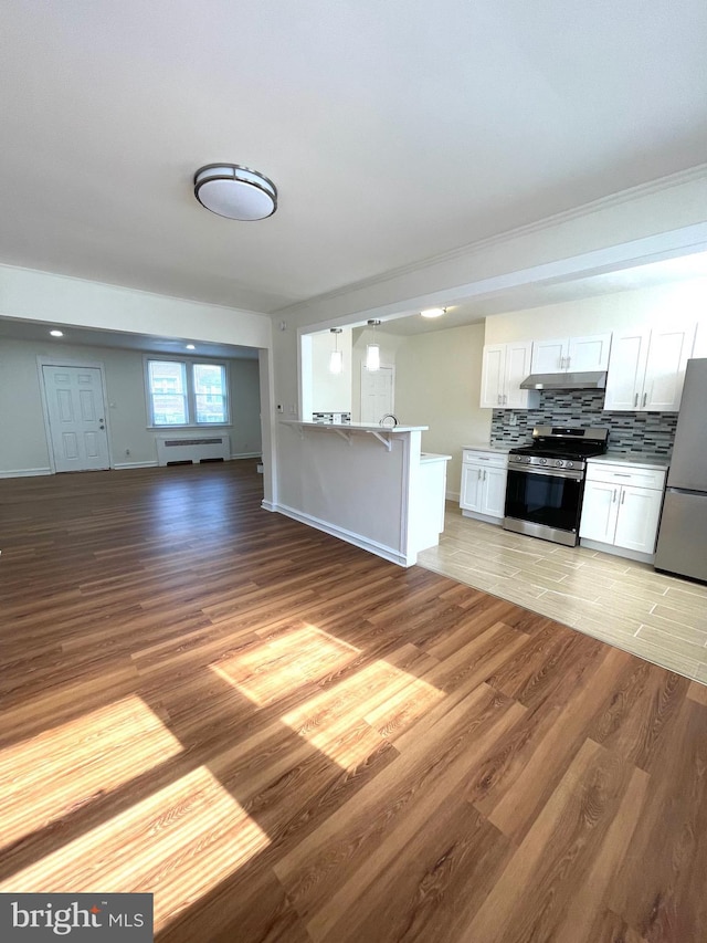 unfurnished living room with light wood-type flooring and baseboards