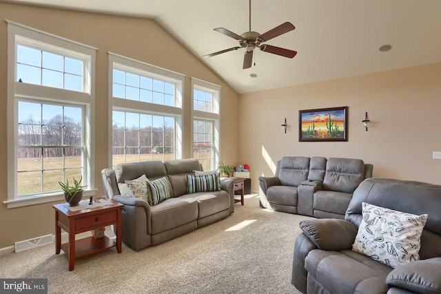 carpeted living room featuring a wealth of natural light, visible vents, high vaulted ceiling, and a ceiling fan