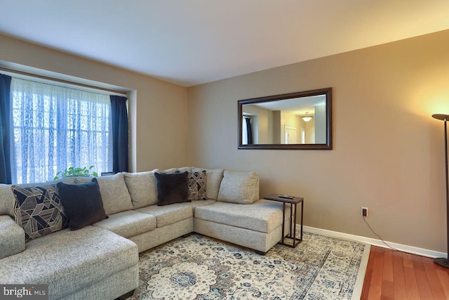 living room featuring baseboards and wood finished floors