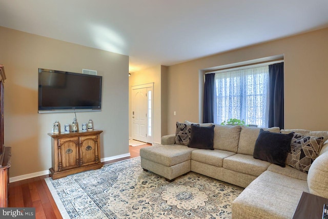 living room featuring baseboards and wood-type flooring