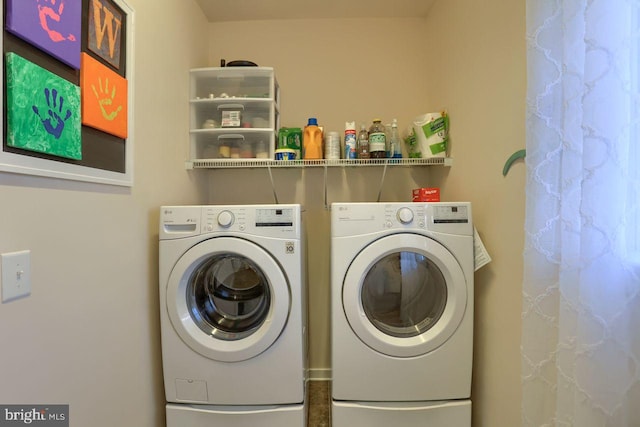 laundry room with washer and dryer and laundry area