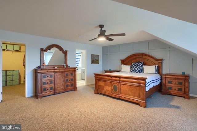 carpeted bedroom with a spacious closet, ceiling fan, a wall unit AC, a closet, and a decorative wall