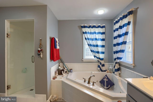 full bath featuring vanity, a shower stall, and a whirlpool tub