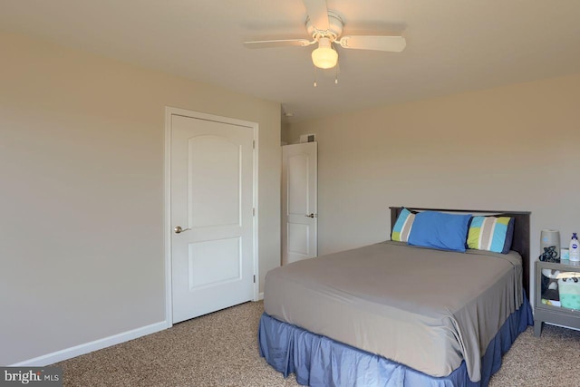 bedroom featuring baseboards, light carpet, and ceiling fan