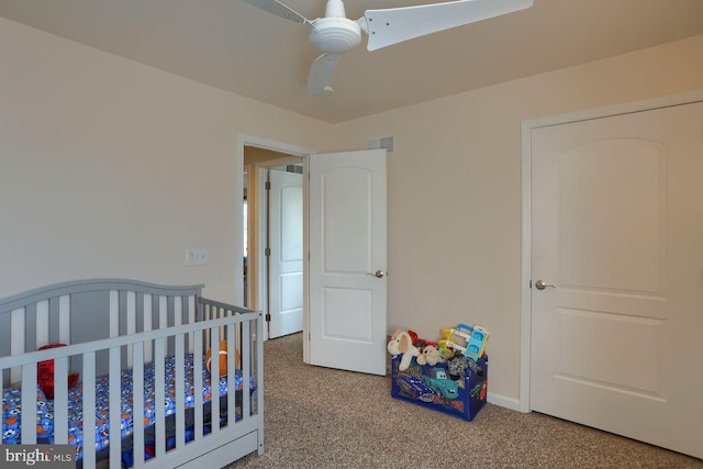 carpeted bedroom with visible vents and ceiling fan