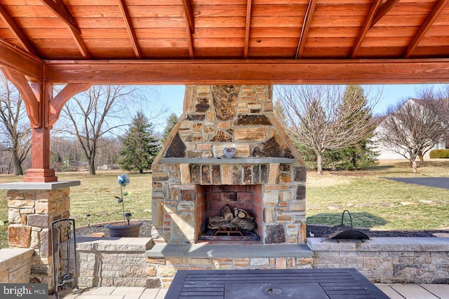 view of patio / terrace featuring an outdoor stone fireplace