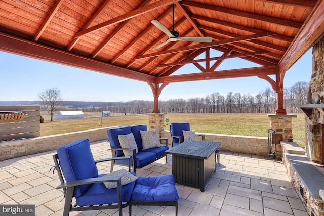 view of patio with an outdoor living space and a gazebo