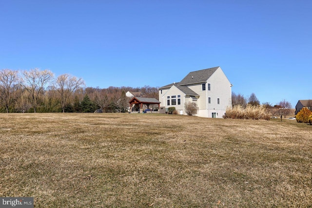 view of side of property with a gazebo and a lawn