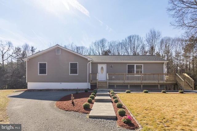 single story home with driveway and a front lawn