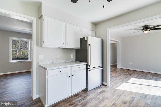 kitchen with a ceiling fan, white cabinets, light countertops, and freestanding refrigerator