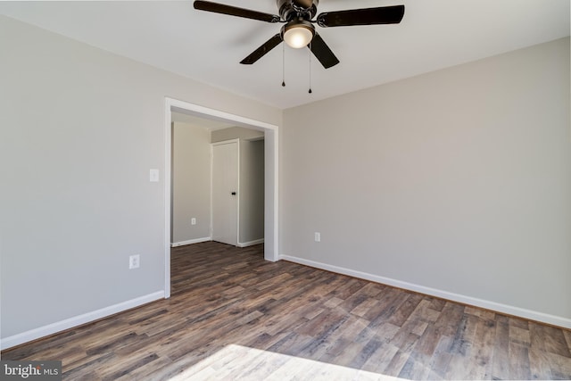 unfurnished room featuring a ceiling fan, baseboards, and wood finished floors