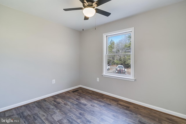 unfurnished room featuring visible vents, a ceiling fan, baseboards, and dark wood-style flooring