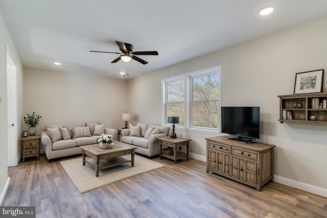 living area featuring recessed lighting, ceiling fan, baseboards, and wood finished floors