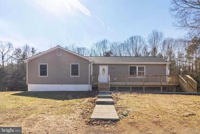 view of front of property with a deck and a front yard