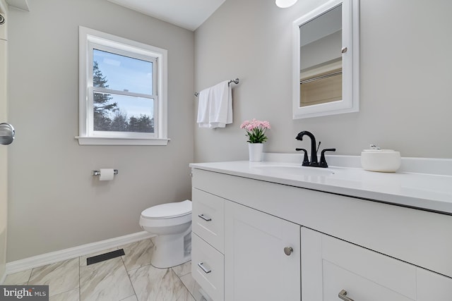 bathroom featuring baseboards, toilet, marble finish floor, and vanity