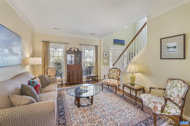 living room with stairway, wood finished floors, visible vents, and ornamental molding