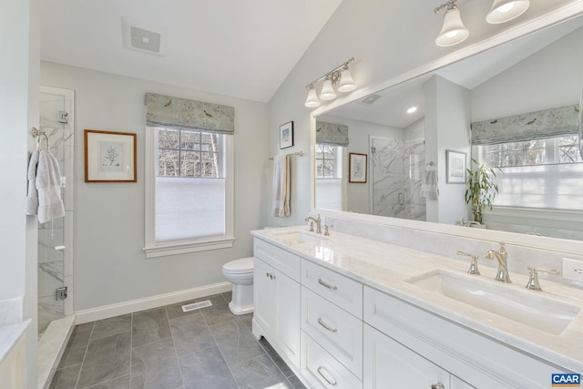 full bathroom with a sink, a marble finish shower, and lofted ceiling