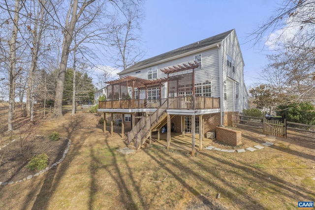 rear view of house featuring a lawn, a pergola, fence, stairway, and a wooden deck