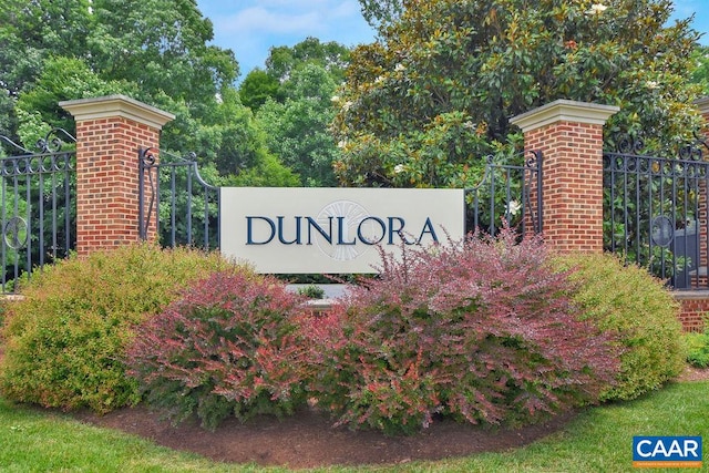 community sign featuring fence