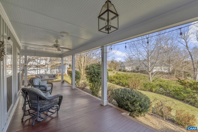 sunroom featuring a ceiling fan