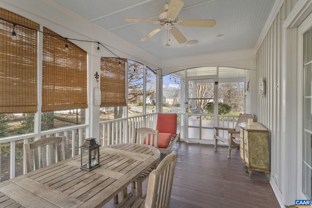 sunroom / solarium with a ceiling fan