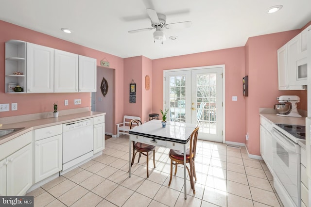 kitchen with white cabinets, white appliances, light countertops, and french doors