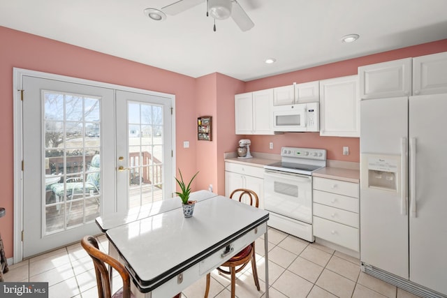 kitchen with french doors, white appliances, white cabinets, light countertops, and light tile patterned floors