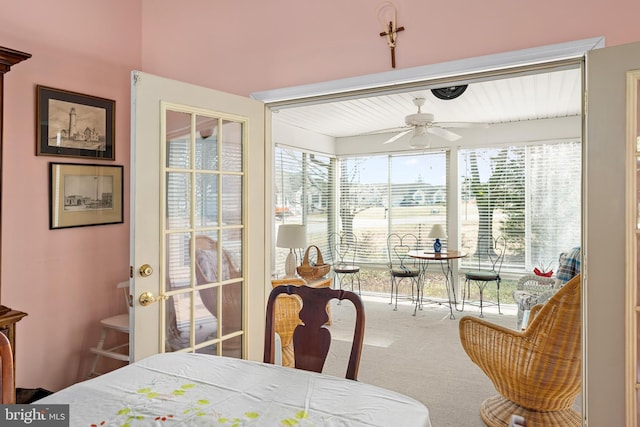 carpeted dining space featuring a ceiling fan