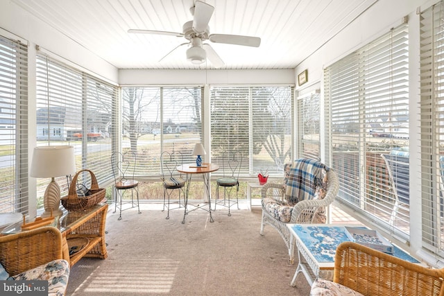 sunroom featuring a wealth of natural light and a ceiling fan