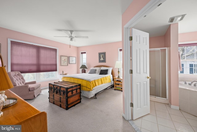 bedroom featuring light tile patterned flooring, visible vents, light colored carpet, and ceiling fan