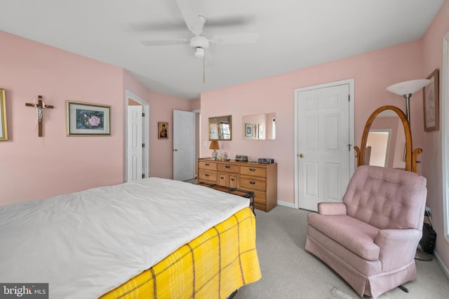 bedroom featuring baseboards and light colored carpet