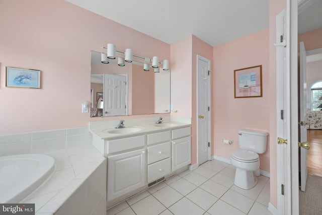 bathroom with tile patterned floors, double vanity, toilet, and a sink