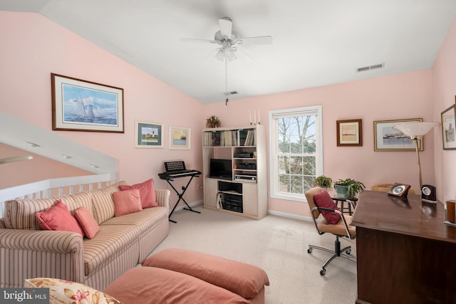 carpeted home office featuring lofted ceiling, baseboards, visible vents, and ceiling fan